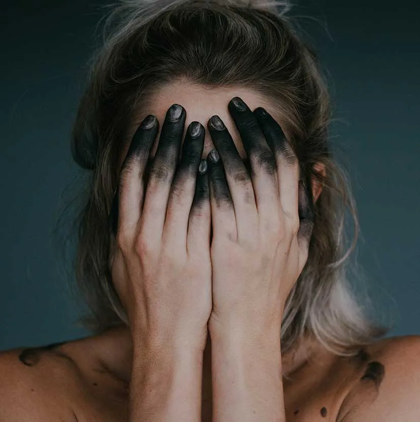 Woman with Black Fingers Covering her Face Woman with Black Fingers Covering her Face
